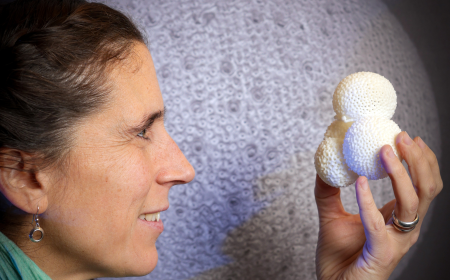 A woman holding a 3D printed foraminifera